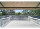 Outdoor balcony with white railings offers treetop views and plenty of space for seating at 370 Sugar Mill Dr, Osprey, FL 34229