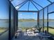 Enjoy beautiful lake views from this cozy screened-in patio with comfortable seating and serene ambiance at 6404 Silverstar Dr, Sarasota, FL 34240