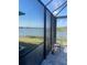 Relax on the screened patio and enjoy serene lake views, a perfect spot to unwind at 6404 Silverstar Dr, Sarasota, FL 34240