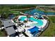 A large, resort-style pool with a waterslide and surrounding lounge area, perfect for relaxing and enjoying the Florida sunshine at 8684 Canyon Creek Trl, Parrish, FL 34219