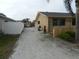 Long gravel driveway and backyard area featuring a storage shed and lush foliage at 9400 Ridge Rd, Seminole, FL 33772