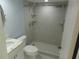 Light bathroom highlighting a glass shower, white cabinets, and tiled floors at 9400 Ridge Rd, Seminole, FL 33772