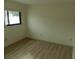 Bright bedroom featuring wood flooring and a window providing natural light at 9400 Ridge Rd, Seminole, FL 33772