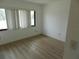 Neutral bedroom featuring a large window with wood-look floors at 9400 Ridge Rd, Seminole, FL 33772