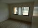 Neutral bedroom with two large windows and wood-look floors at 9400 Ridge Rd, Seminole, FL 33772