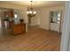 Bright dining room features a chandelier, a wet bar, and wood-look floors at 9400 Ridge Rd, Seminole, FL 33772