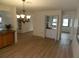 Bright dining room showcases wood-look floors, a chandelier, and a wet bar at 9400 Ridge Rd, Seminole, FL 33772