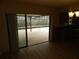 Open dining area with wood floors and sliding doors leading to the screened pool area at 9400 Ridge Rd, Seminole, FL 33772