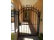 Arched wrought iron gate leads to the front door and light-filled interior at 9400 Ridge Rd, Seminole, FL 33772