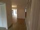 Inviting hallway showcasing the home's layout with wood flooring and ample closet space at 9400 Ridge Rd, Seminole, FL 33772