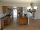 Open kitchen boasts wooden cabinetry, granite counters, and an island at 9400 Ridge Rd, Seminole, FL 33772