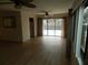 Light-filled living room featuring wood-look floors and sliding doors to the pool at 9400 Ridge Rd, Seminole, FL 33772