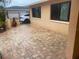 Private patio features brick pavers surrounded by the stucco wall of the home at 9400 Ridge Rd, Seminole, FL 33772