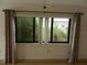 Bright view from a window of tropical landscaping and an adjacent building at 9400 Ridge Rd, Seminole, FL 33772