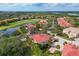 Stunning aerial view of a golf course, serene lake, and lush greenery surrounding the property at 9606 Sea Turtle Ter # 101, Bradenton, FL 34212