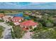 An aerial shot of the home, close to a lake and surrounded by lush green trees at 9606 Sea Turtle Ter # 101, Bradenton, FL 34212