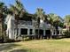 A spacious home featuring an airy balcony overlooking lush landscaped grounds with mature palm trees at 9606 Sea Turtle Ter # 101, Bradenton, FL 34212