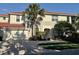 Beautiful two-story home featuring a two-car garage, a red tile roof and lush tropical landscaping at 9606 Sea Turtle Ter # 101, Bradenton, FL 34212