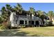 A spacious home featuring an airy balcony overlooking lush landscaped grounds with mature palm trees at 9606 Sea Turtle Ter # 101, Bradenton, FL 34212