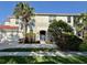 Beautiful two-story home with lush landscaping, a red tile roof and a welcoming blue front door at 9606 Sea Turtle Ter # 101, Bradenton, FL 34212