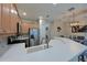 Bright kitchen featuring stainless steel appliances and a large white countertop island with a sink and faucet at 9606 Sea Turtle Ter # 101, Bradenton, FL 34212