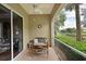 Relaxing screened-in lanai with comfortable seating overlooking a lush landscape and pond at 9606 Sea Turtle Ter # 101, Bradenton, FL 34212
