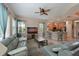 Inviting living room with comfortable seating, ceiling fan, and an open layout to the kitchen at 9606 Sea Turtle Ter # 101, Bradenton, FL 34212