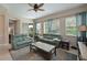 Inviting living room with comfortable seating, ceiling fan, and multiple bright windows at 9606 Sea Turtle Ter # 101, Bradenton, FL 34212