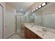 Spacious main bathroom featuring double sinks, tiled floor, and a glass enclosed walk-in shower at 9606 Sea Turtle Ter # 101, Bradenton, FL 34212