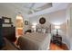 Comfortable main bedroom with a ceiling fan, hardwood floors, and an arched entryway to the main bathroom at 9606 Sea Turtle Ter # 101, Bradenton, FL 34212
