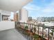 Condo balcony overlooking city streets with palm trees and building views at 101 S Gulfstream Ave # 10E, Sarasota, FL 34236