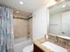 This bathroom features a vanity with granite countertops and a shower-tub combo with a decorative tile accent at 101 S Gulfstream Ave # 10E, Sarasota, FL 34236
