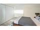 This bedroom has a neutral palette and a view out of the large picture window with an additional large closet at 101 S Gulfstream Ave # 10E, Sarasota, FL 34236
