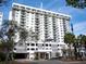 Exterior view of a condominium building with an American flag at 101 S Gulfstream Ave # 10E, Sarasota, FL 34236