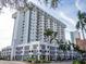 Low angle exterior of a tall condo building with palm trees and views of the city at 101 S Gulfstream Ave # 10E, Sarasota, FL 34236