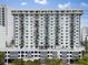 Exterior view of a modern high-rise condo building with balconies and a rooftop pool at 101 S Gulfstream Ave # 10E, Sarasota, FL 34236