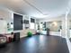Spacious gym featuring rubber flooring, mirrors, a TV, exercise equipment, and fitness accessories at 101 S Gulfstream Ave # 10E, Sarasota, FL 34236