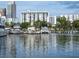 Waterfront scene of a marina showcasing several yachts and views of city buildings at 101 S Gulfstream Ave # 10E, Sarasota, FL 34236