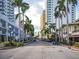 Inviting street view with palm trees lining the road and modern buildings in a bustling city center at 101 S Gulfstream Ave # 10E, Sarasota, FL 34236