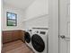 Well-lit laundry room with modern washer and dryer units, cabinets and plenty of counter space at 11323 Rivers Bluff Cir, Lakewood Ranch, FL 34202