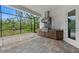 Outdoor kitchen features a built-in grill, stainless steel vent hood, and screened-in patio at 11323 Rivers Bluff Cir, Lakewood Ranch, FL 34202