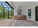 Covered outdoor kitchen includes a built-in grill, countertop space and screened-in patio at 11323 Rivers Bluff Cir, Lakewood Ranch, FL 34202