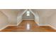 A finished attic space featuring hardwood floors, a dormer window, and neutral wall color at 1825 Bayshore Dr, Terra Ceia, FL 34250