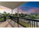 Enjoy the serene waterfront view from this tiled balcony with black railings at 1825 Bayshore Dr, Terra Ceia, FL 34250