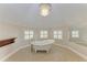 A bathroom featuring tile floors, neutral walls, a claw foot tub, and natural light at 1825 Bayshore Dr, Terra Ceia, FL 34250