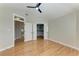 Neutral bedroom featuring hardwood floors, walk-in closet, ceiling fan and a neutral color palette at 1825 Bayshore Dr, Terra Ceia, FL 34250