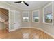 Bright bedroom with wood floors, natural light, ceiling fan, and neighborhood views at 1825 Bayshore Dr, Terra Ceia, FL 34250