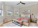 This bedroom offers natural light, neutral paint, and hardwood flooring with a decorative rug at 1825 Bayshore Dr, Terra Ceia, FL 34250