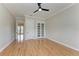 Spacious bedroom with hardwood floors, ceiling fan, and French doors at 1825 Bayshore Dr, Terra Ceia, FL 34250