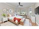 Bright bedroom with hardwood floors, natural light, a ceiling fan, and neutral decor at 1825 Bayshore Dr, Terra Ceia, FL 34250